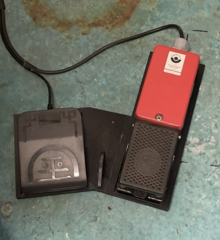 Pedal module holding a USB foot pedal and a laser welder foot pedal side by side